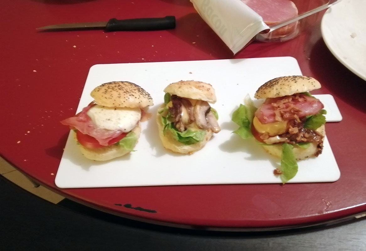3 minis burgers en présentation, sur une photo très très floue